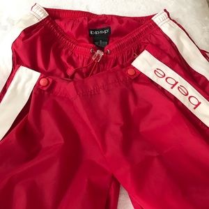 Red Bebe windbreaker/track pants with 2 hidden zippered pockets. Sz Small